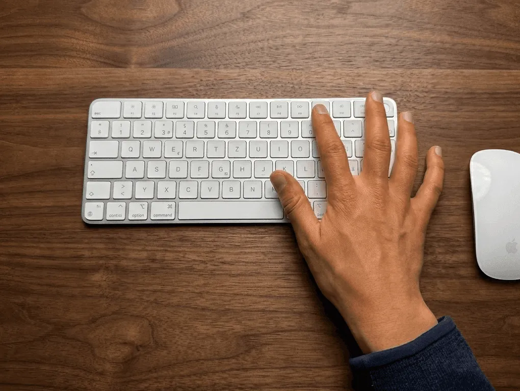 A Mac keyboard's function row alongside the Menu Bar Controller playback controls